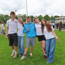 Year 11s celebrating at their end of school party, signing their t-shirts and enjoying ice creams
