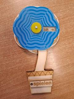 A wooden tool for learning conjugations of German Verbs in the shape of flower