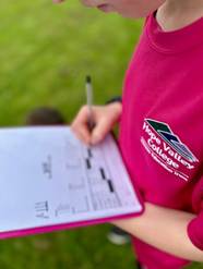 Sports Leader writing on a clipboard
