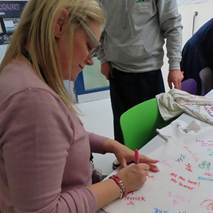 Mrs Petts signing a Year 11 Leaver's polo shirt