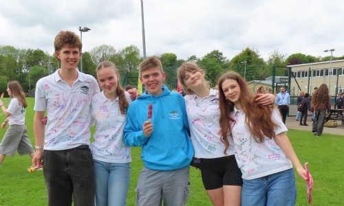 Year 11s celebrating at their end of school party, signing their t-shirts and enjoying ice creams
