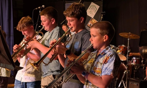 Four students playing the trumpet at Music and Mayhem event